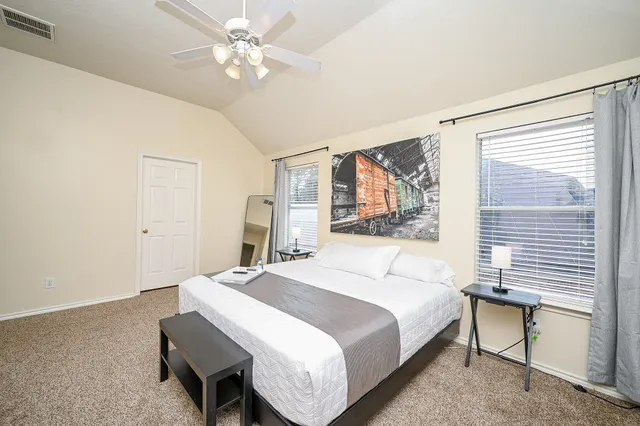 a bedroom with a bed and a window