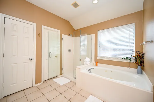 a bathroom with a bathtub and a shower