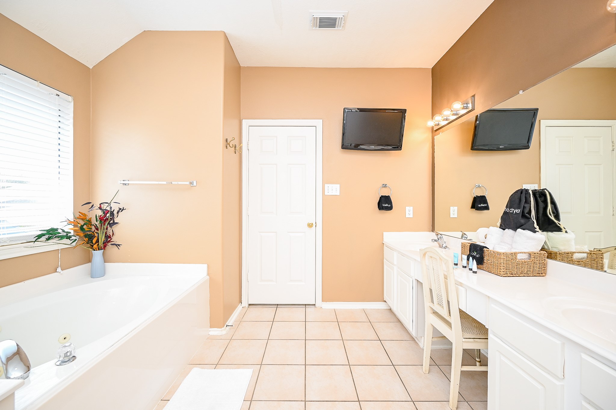 12122 Lucky Meadow Drive Tomball, TX 77375 - Photo 28 of 32 a bathroom with a sink a mirror and a bathtub