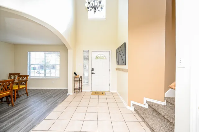 a view of a living room with furniture and wooden floor