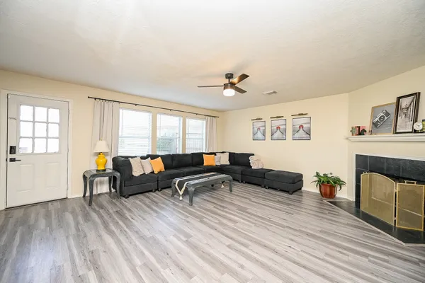 a living room with furniture and a wooden floor