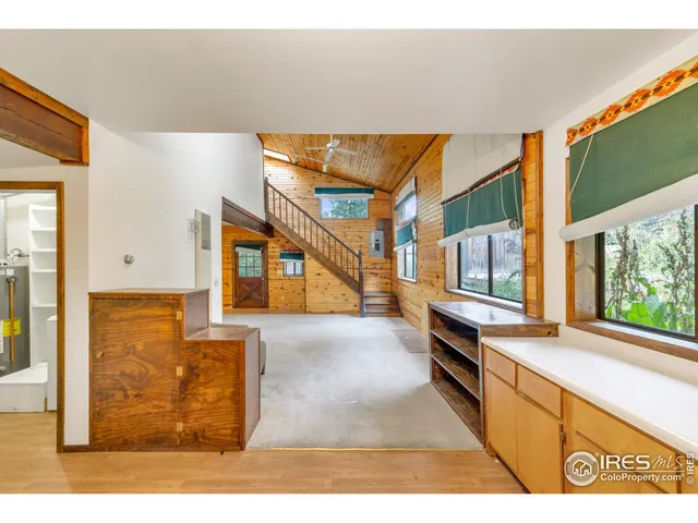 a open kitchen with cabinets and window