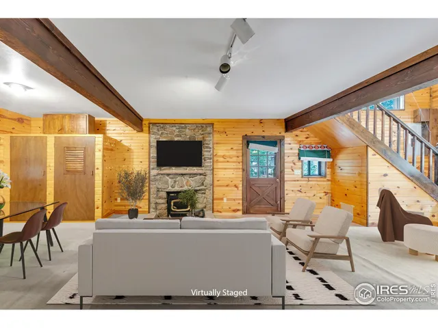 a living room with furniture a flat screen tv and a floor to ceiling window