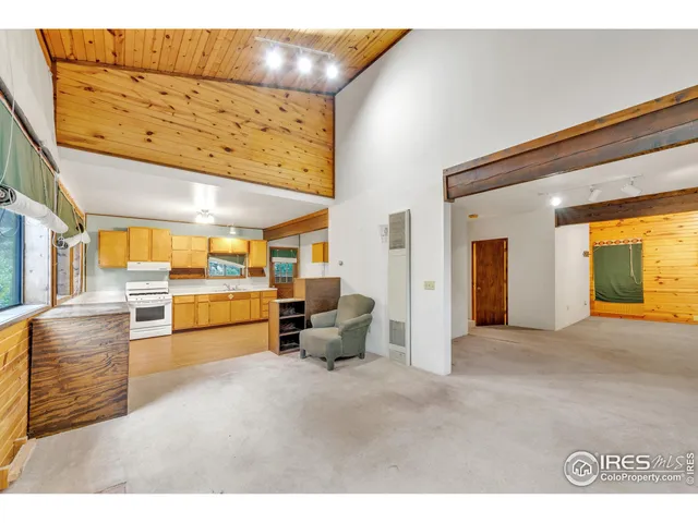a view of a living room and kitchen with furniture