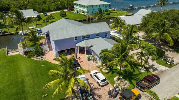an aerial view of a house with a swimming pool patio and outdoor seating