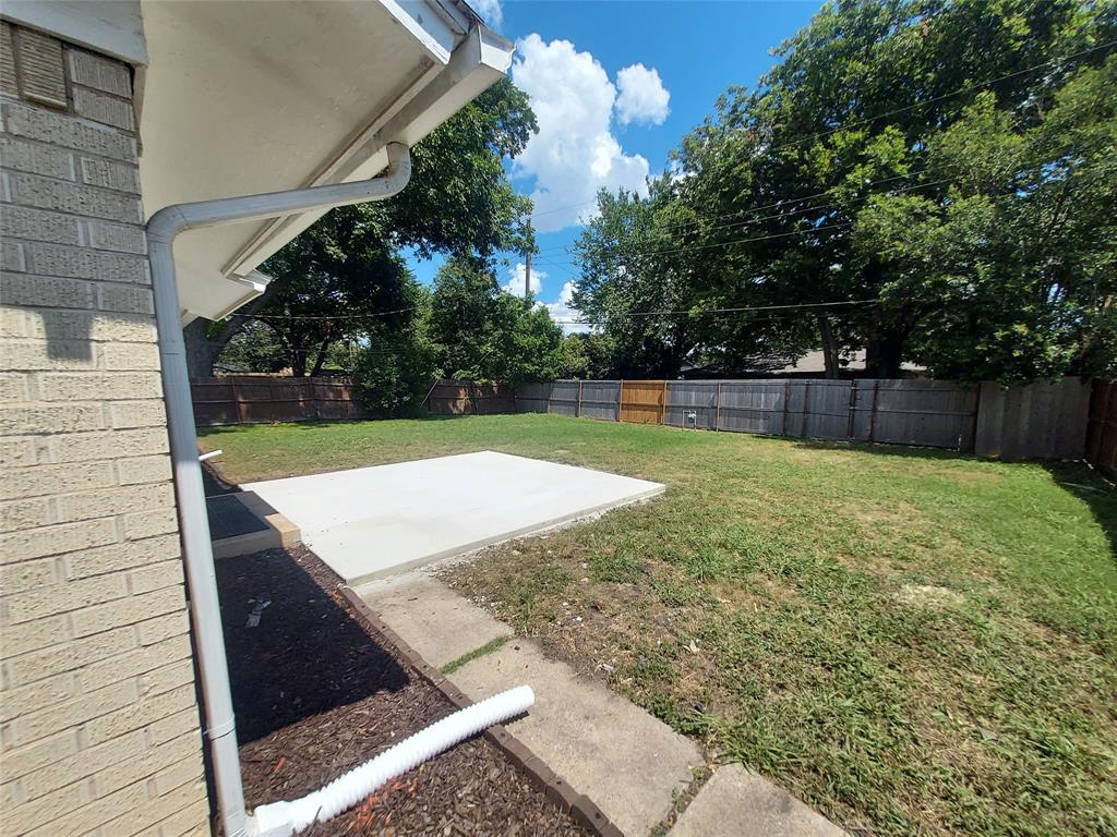6900 Skillman Street, Unit 404 Dallas, TX 75231 - Photo 2 of 10 Fenced backyard featuring a patio area