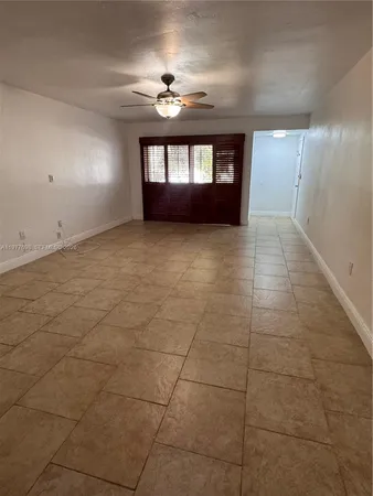 a view of wooden floor and windows in a room