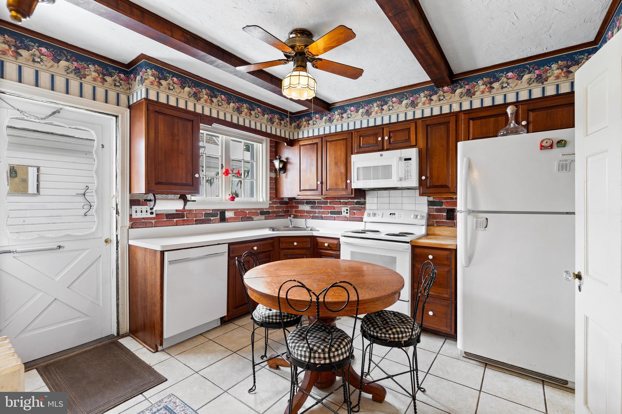 506 Spring Lane Wyndmoor, PA 19038 - Photo 12 of 29 a kitchen with stainless steel appliances granite countertop a stove a refrigerator and a sink
