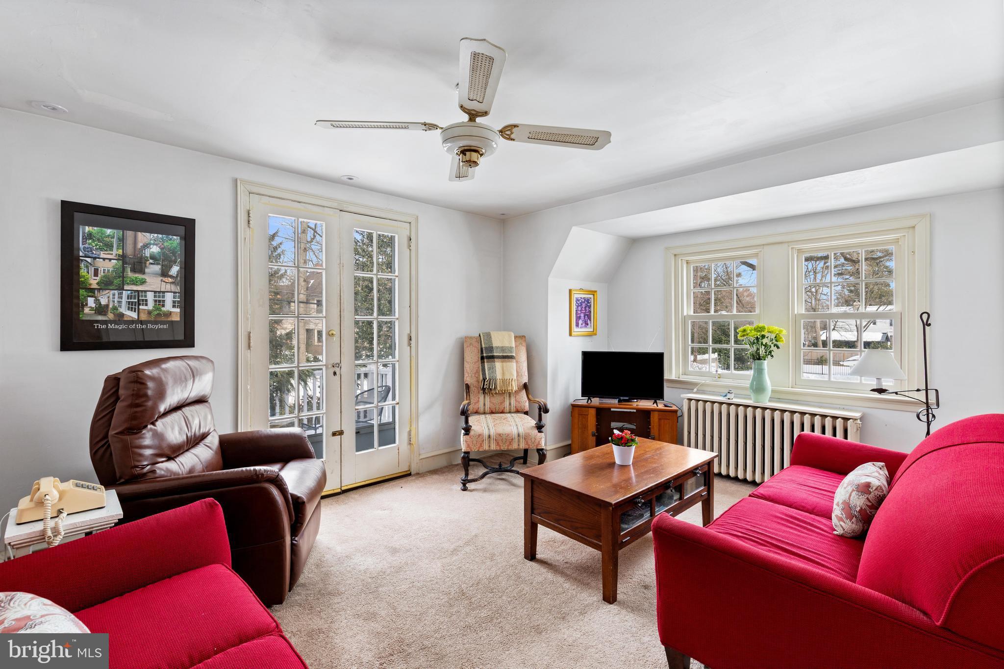 506 Spring Lane Wyndmoor, PA 19038 - Photo 21 of 29 a living room with furniture a flat screen tv and a window