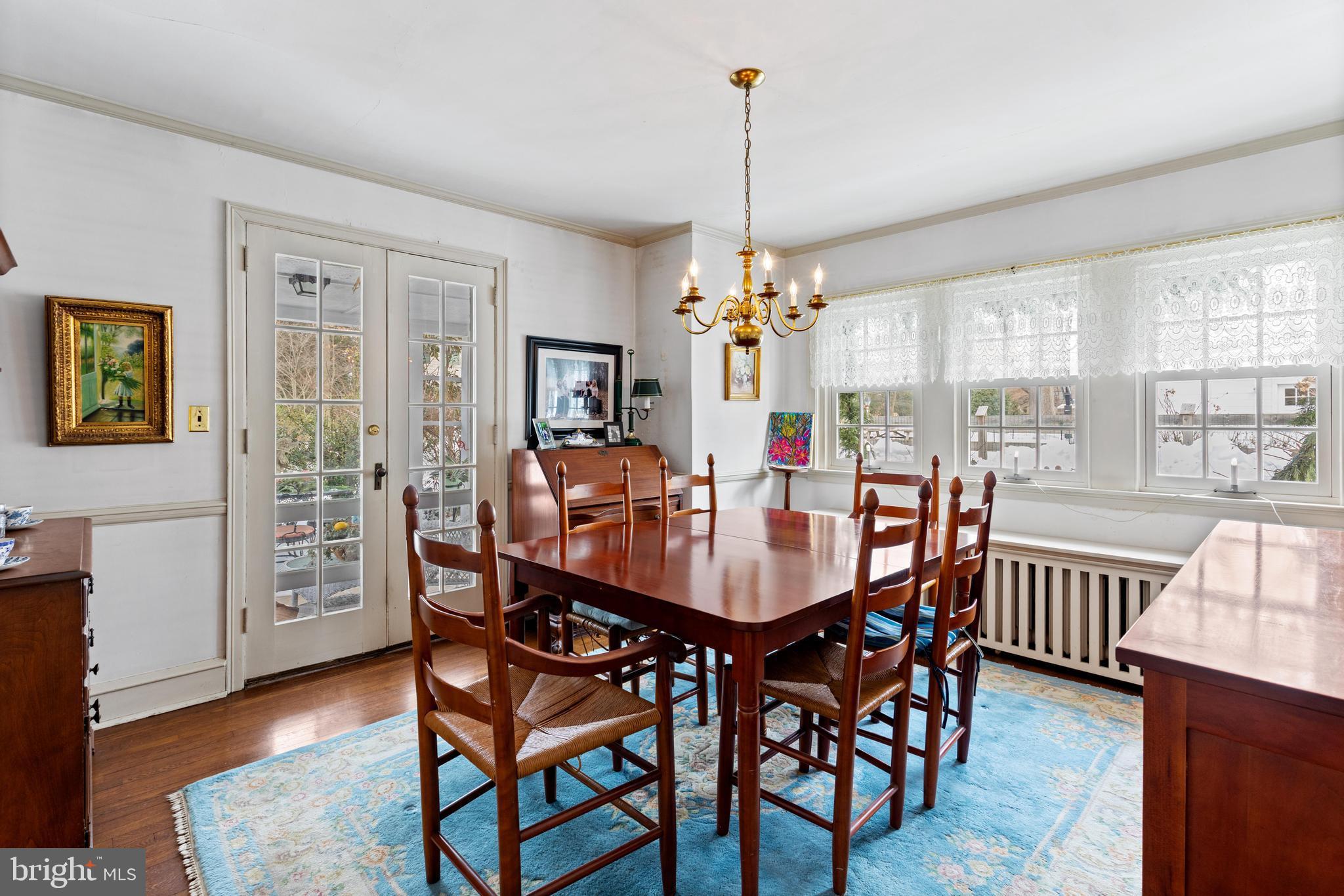 506 Spring Lane Wyndmoor, PA 19038 - Photo 9 of 29 a view of a dining room and livingroom with furniture wooden floor a chandelier