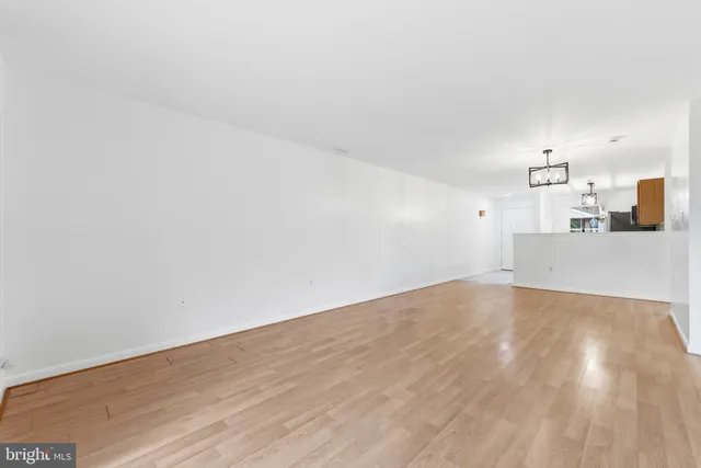 a view of a kitchen with wooden floor and a sink