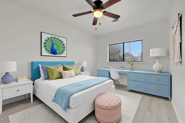 a spacious bedroom with a bed and a chandelier