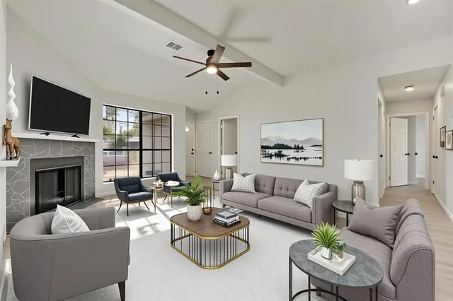 a living room with furniture flat screen tv and a fireplace