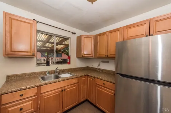 a kitchen with stainless steel appliances granite countertop a refrigerator sink and cabinets