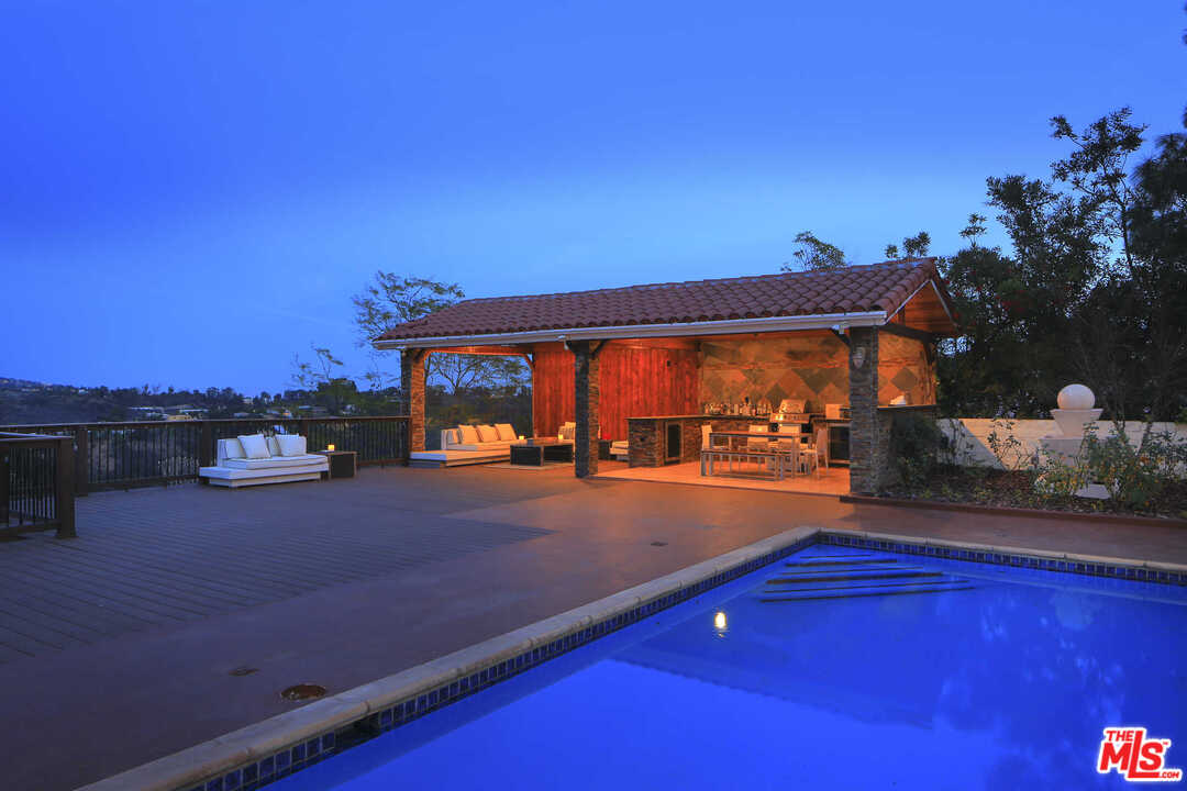 1410 Stradella Road Los Angeles, CA 90077 - Photo 15 of 24 a backyard of a house with table and chairs