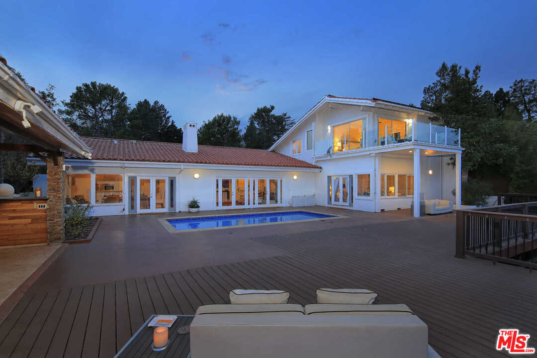 1410 Stradella Road Los Angeles, CA 90077 - Photo 16 of 24 a front view of a house with garden