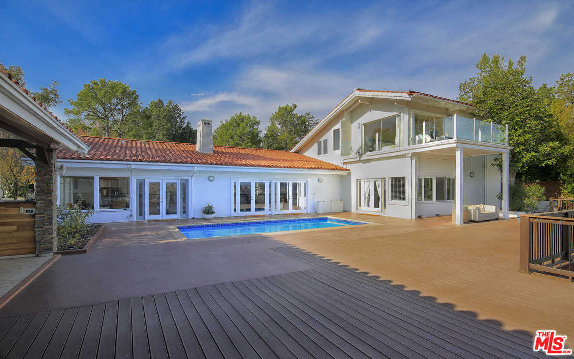 1410 Stradella Road Los Angeles, CA 90077 - Photo 18 of 24 a front view of a house with a yard