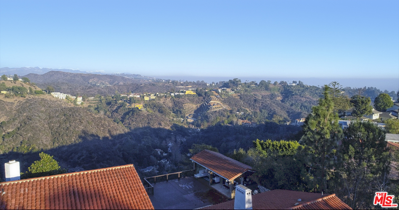 1410 Stradella Road Los Angeles, CA 90077 - Photo 21 of 24 a view of a terrace with a table and chairs