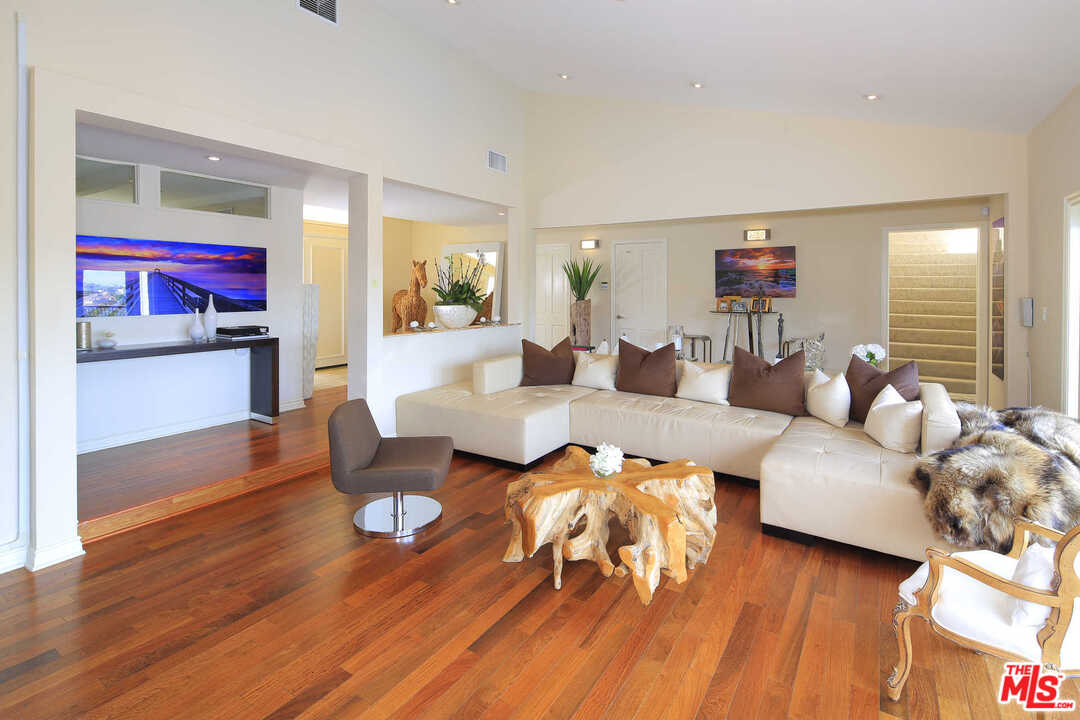 1410 Stradella Road Los Angeles, CA 90077 - Photo 9 of 24 a living room with furniture and a wooden floor