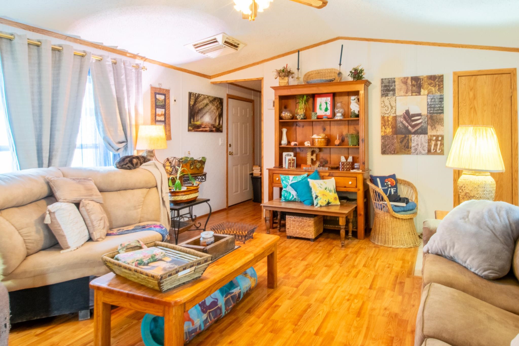 435 32 Road, Unit 437 Clifton, CO 81520 - Photo 3 of 29 a living room with furniture a flat screen tv and a window