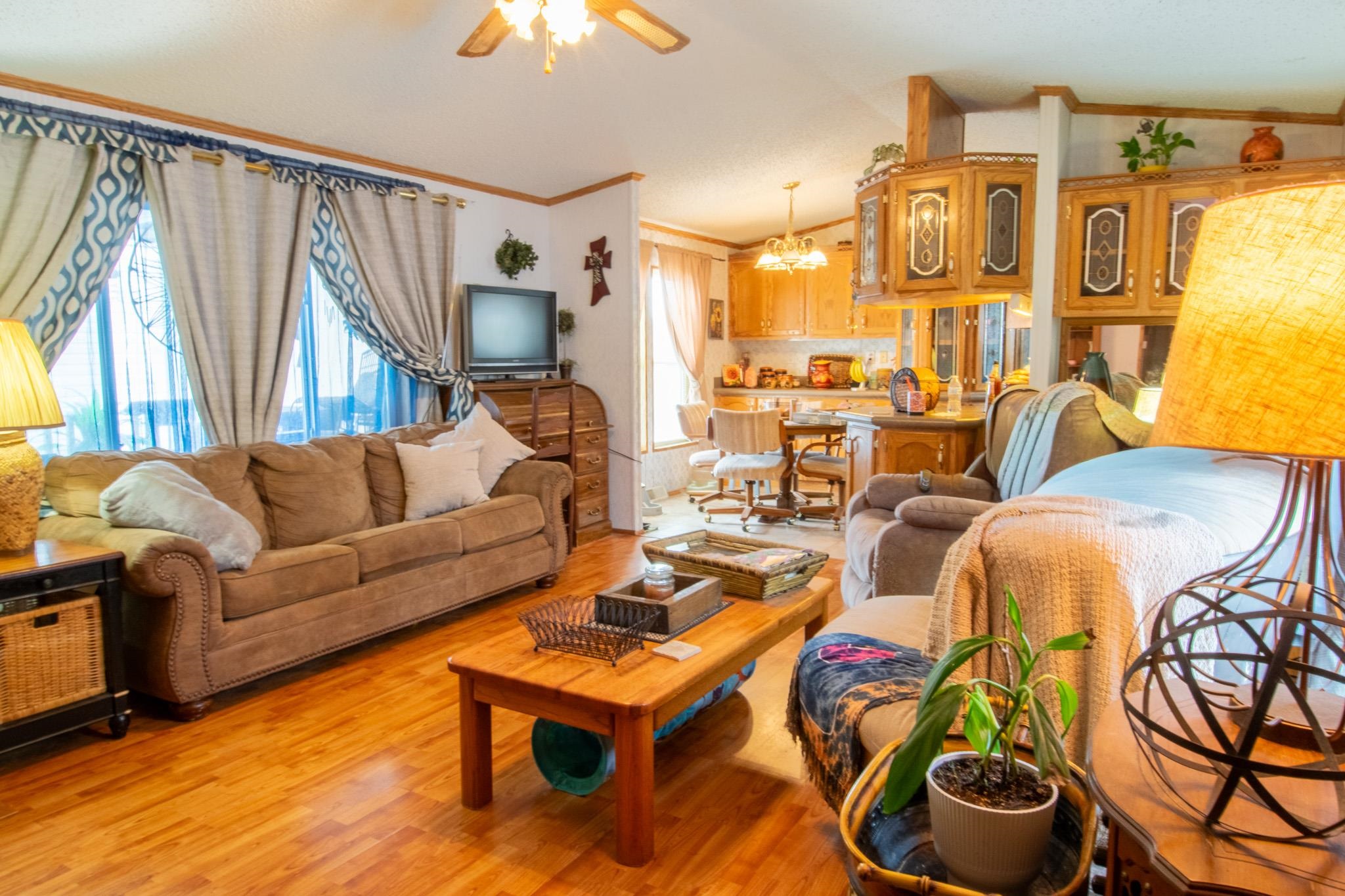 435 32 Road, Unit 437 Clifton, CO 81520 - Photo 5 of 29 a living room with furniture a fireplace and a large window