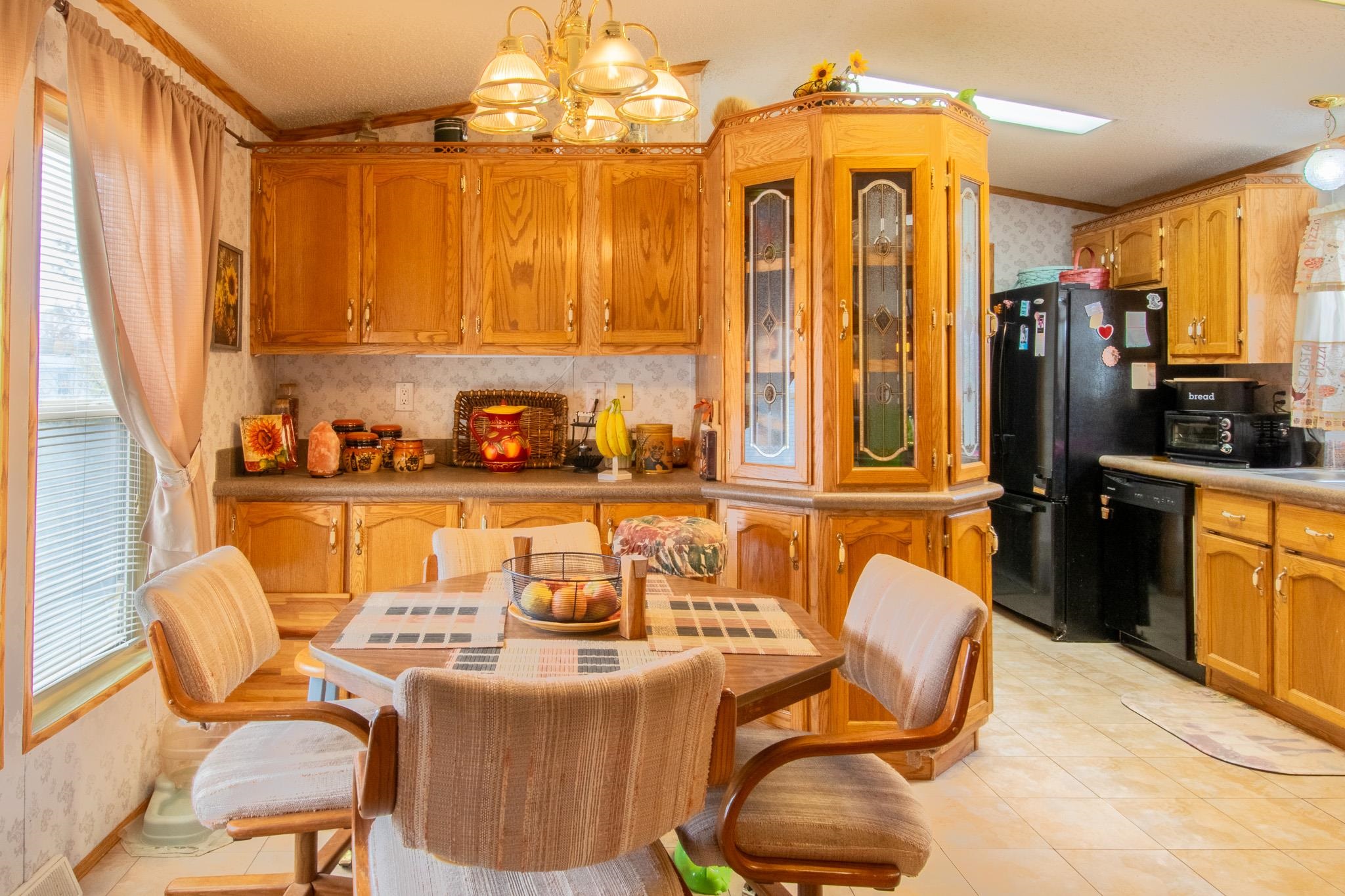 435 32 Road, Unit 437 Clifton, CO 81520 - Photo 6 of 29 a dining room with stainless steel appliances granite countertop a sink a refrigerator and chairs