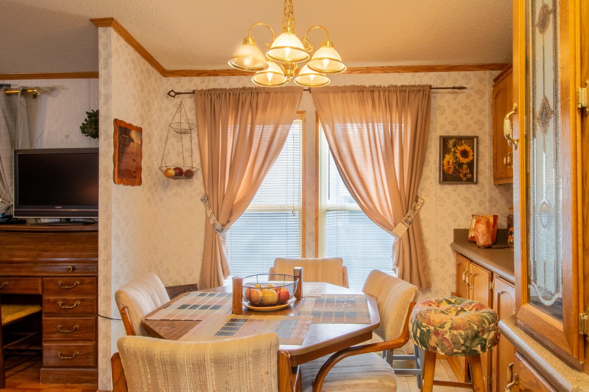 435 32 Road, Unit 437 Clifton, CO 81520 - Photo 7 of 29 a dining room with furniture and a flat screen tv