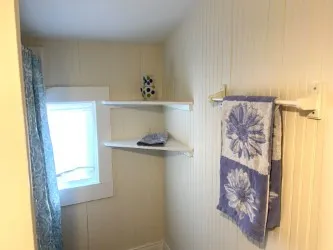 a room with a painting on the wall and a window