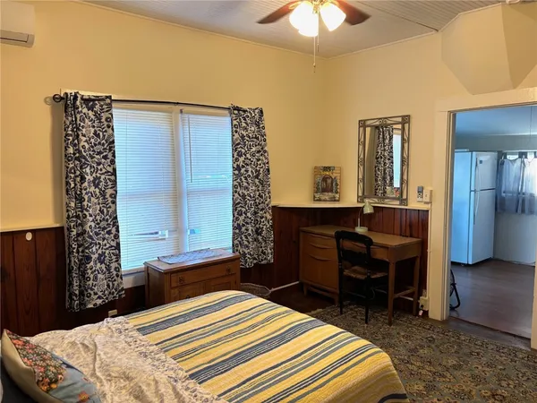 a bedroom with a bed and a chandelier