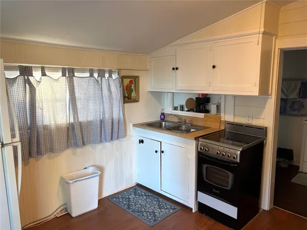 a kitchen with stainless steel appliances a stove a sink and a refrigerator