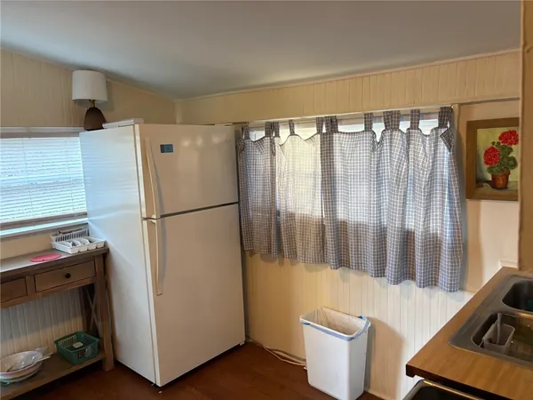 a kitchen with a refrigerator and sink