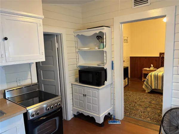 a kitchen with a refrigerator and a stove