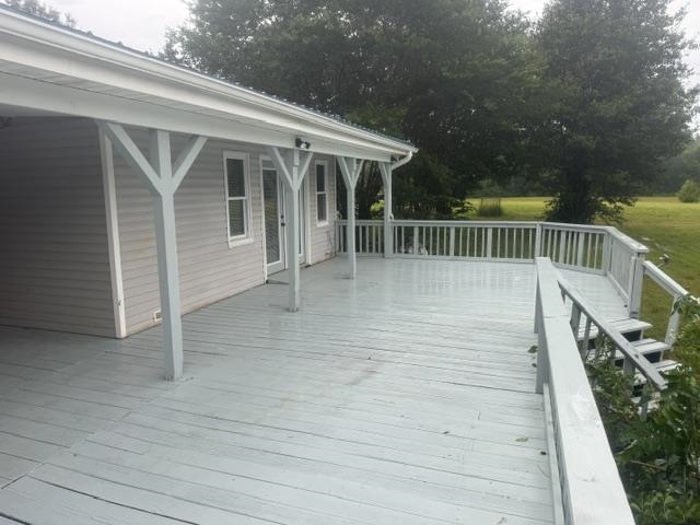 1100 Pine Top Road Toone, TN 38381 - Photo 30 of 40 Expansive wooden deck featuring perimeter railing, a multi-level design, and direct access to the interior through a glass-paneled door