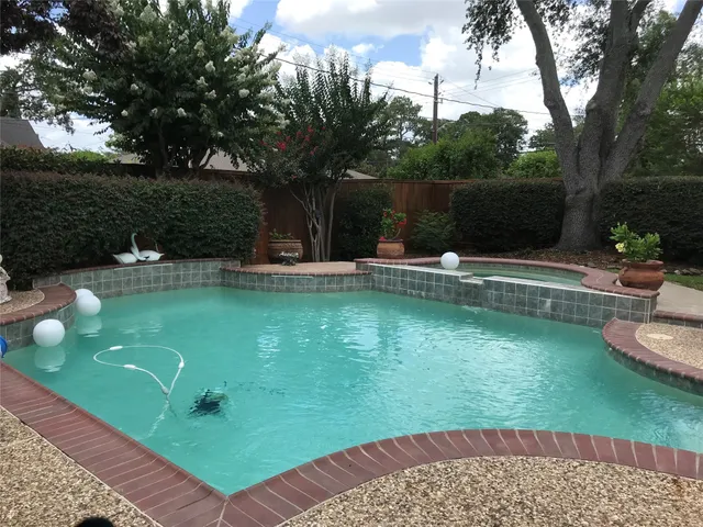 a view of a swimming pool with a patio