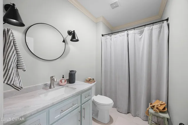 a bathroom with a toilet a sink and a mirror
