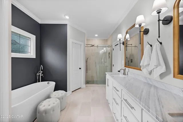 a bathroom with a tub sink and mirror