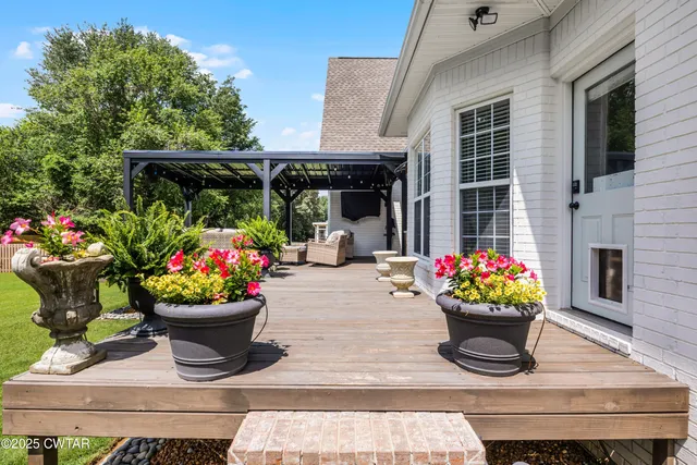a view of a porch with flowers and flowers