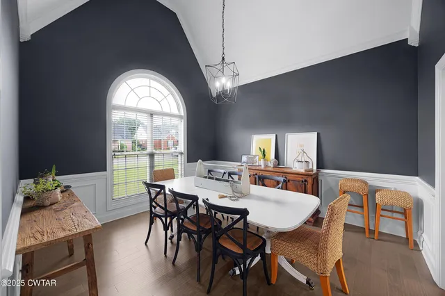 a view of a dining room with furniture and a window