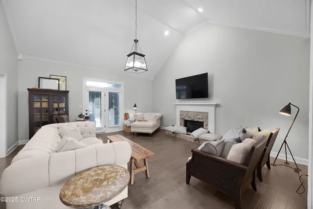 a living room with furniture a fireplace and a flat screen tv