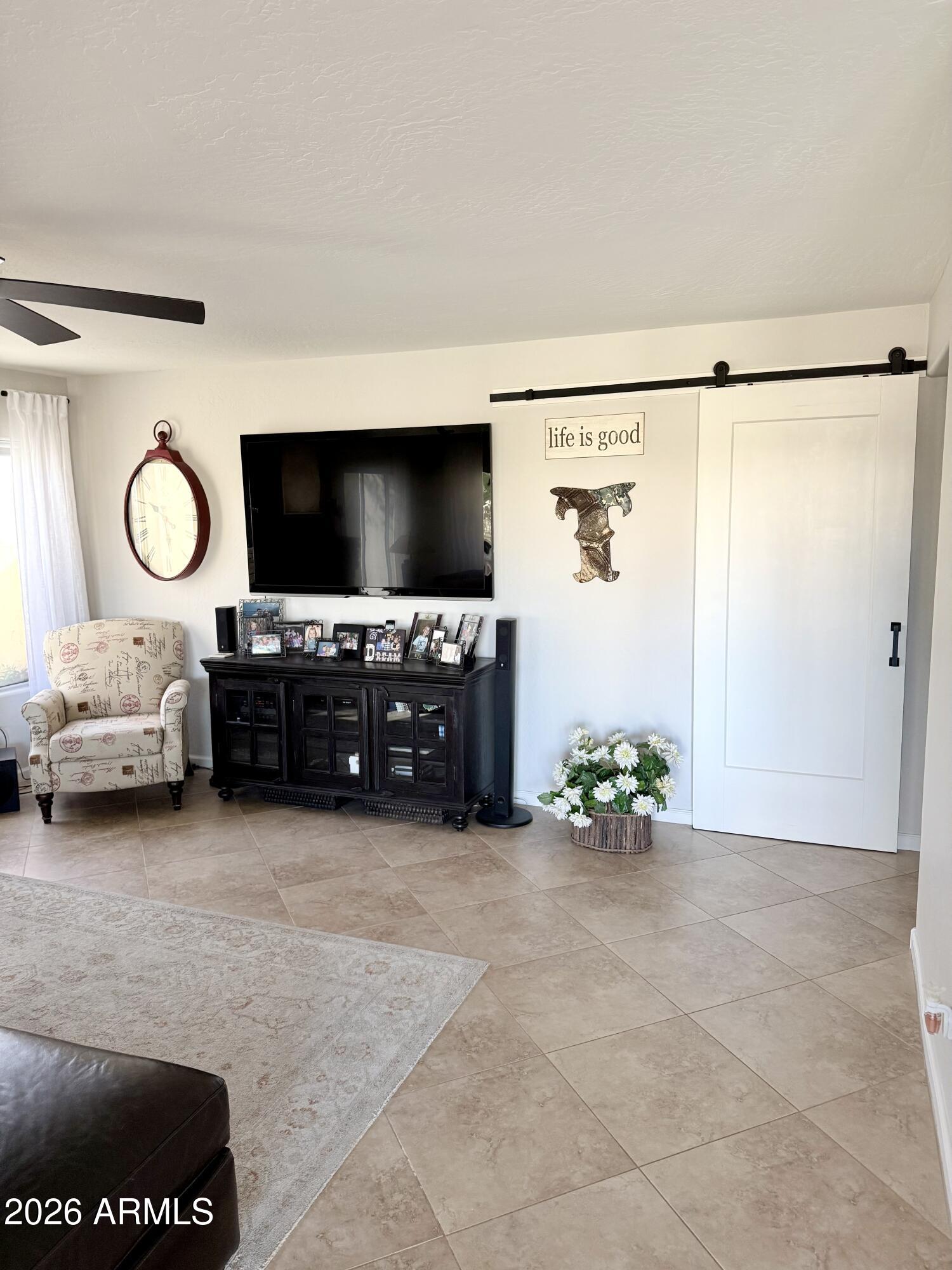 3426 East Clark Road Phoenix, AZ 85050 - Photo 6 of 48 a living room with furniture and a flat screen tv