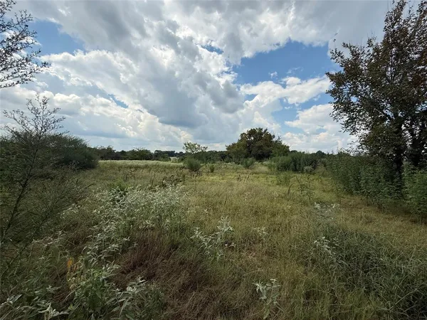 a view of a lake with houses in back