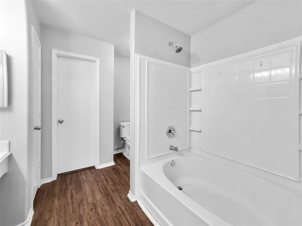 a bathroom with a bathtub and a shower