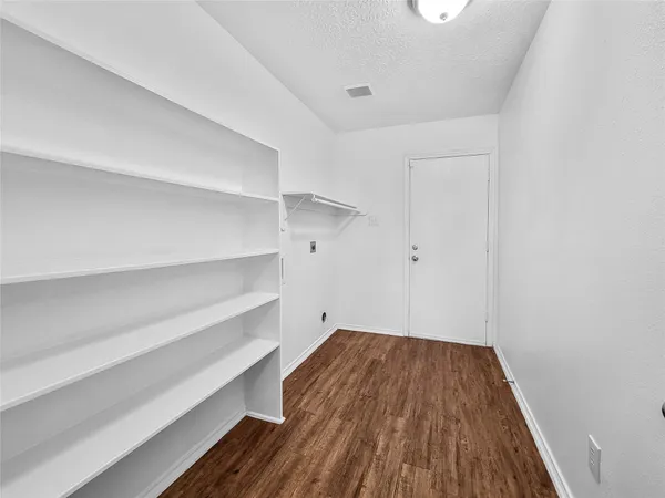 a view of room with wooden floor and staircase