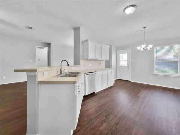 a kitchen with sink and cabinets