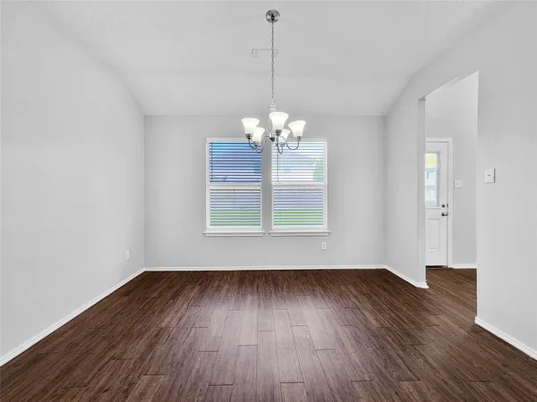 a view of a room with wooden floor and window