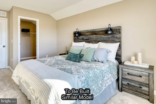 a bedroom with a bed and a desk