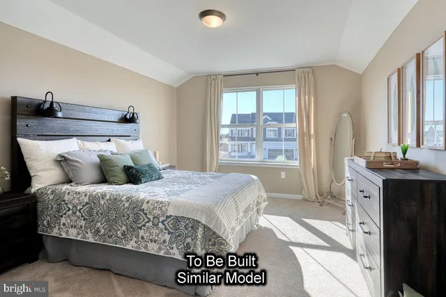 a bedroom with a bed and a dresser next to a window