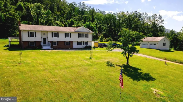 a view of a house with pool and deck