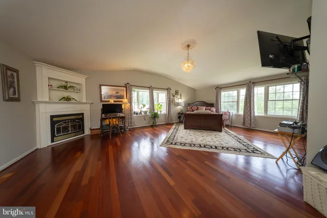 a living room with furniture rug and a table
