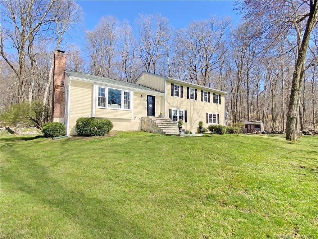 72 Longmeadows Road Wilton, CT 06897 - Photo 1 of 1 a white house that has a big yard in front of it